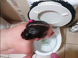 Chubby teen licking toilet clean and gets pissed on with spit and slap